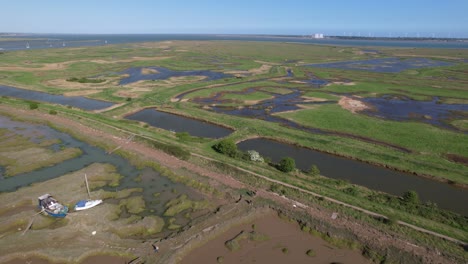Boats-in-Marshy-Swamps-of-Blackwater-River,-Essex,-UK---Aerial-Drone-View
