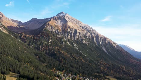 Ascending-shot-up-the-side-of-the-Graubuenden-mountain-surrounded-by-a-dense-forest