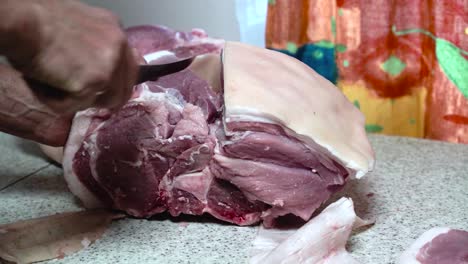 Butchering-bone-in-pork-shoulder-at-home,-separating-meat-with-deboning-knife