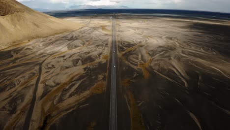 Aerial-Shot-Of-Cars-Driving-On-Long-Straight-Road-In-Iceland