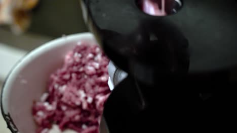 Making-course-ground-pork-from-scratch-at-home-with-meat-grinder,-slow-motion