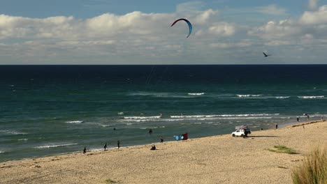 Surfistas-Disfrutando-Del-Fuerte-Viento-En-La-Playa-Tropical-De-Hayle-En-Cornwall,-Inglaterra