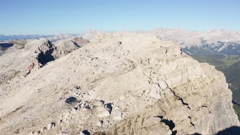 Mountain-peaks-and-rocky-ridge-lines-in-Dolomites,-aerial-wide-view