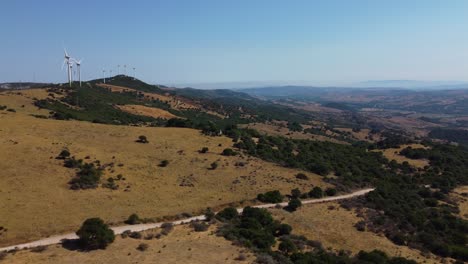 Majestic-Spanish-landscape-with-electricity-windmills-on-hilltop,-aerial-view