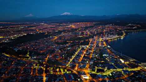 Aerial-Timelapse-over-Puerto-Montt-city-at-dawn-showing-the-evening-lights-over-the-costal-city