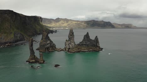 Aerial-Shot-of-Reynisdrangar-Rocks-And-Cliffs-in-Iceland-Moving-Left