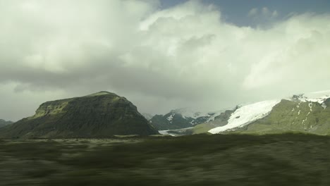 View-From-A-Car-Window-Driving-in-Iceland,-Mountains,-Glacier,-Clouds