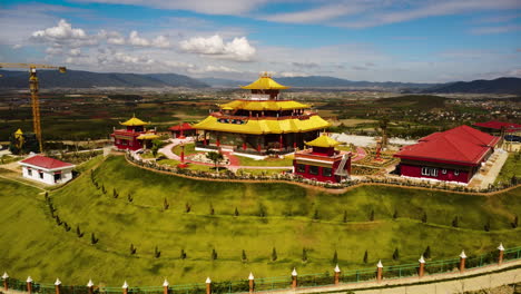 Massive-colorful-temple-in-Vietnam-on-hill-top,-freshly-built,-aerial-orbit-view