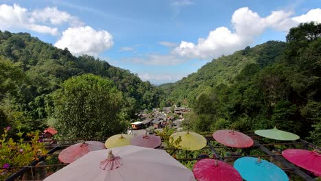 Beautiful-calm-afternoon-with-vibrant-umbrellas-at-high-above-viewpoint-in-nature