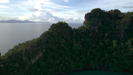 Drone-Ascending-On-Rocky-Forest-Mountains-Revealed-Tanjung-Rhu-Beach-In-Langkawi-Island,-Malaysia