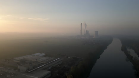 Drone-view-of-smoking-factory-near-Melnik,-Czech-Republic,-air-pollution-during-sunset