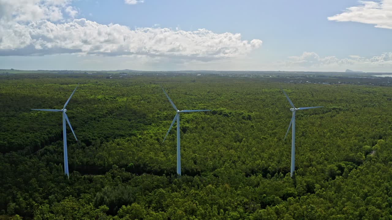 Premium stock video - Drone pullback view of spinning wind turbines in ...