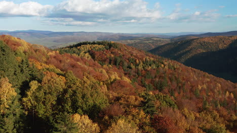 Reverse-aerial-dolly-over-foothills-covered-with-beautiful-autumn-foliage