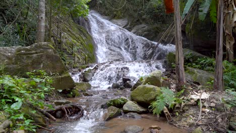 Beautiful-cascading-waterfall-in-lush-green-jungle,-locked-off-view