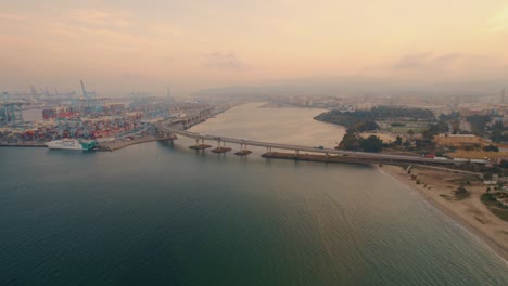 Aerial-view-towards-Port-of-Algeciras-international-shipping-container-terminal-loading-highway-at-sunrise