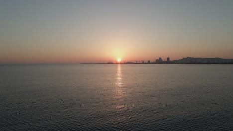 Durres-Container-Port-on-horizon-of-calm-golden-Adriatic-Sea-sunset