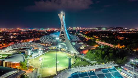 4K-Modern-Olympic-Stadium-building-at-night-in-Montreal-and-soccer-field-besides
