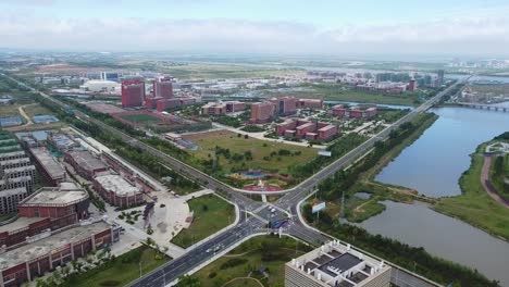 Aerial-cinematic-view-highway-intersection-in-reverse-motion-taken-in-Nanhai-New-District,-China