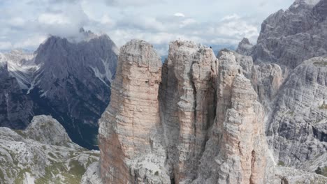 Mountaineer-descending-a-mountain-peak-in-Italian-Dolomites,-Tre-Cime,-aerial-orbit