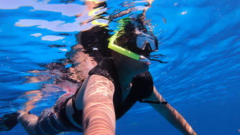 snorkeling-experience-enjoying-in-deep-blue-sea-with-snorkeling-gears-|-Tourist-enjoying-snorkeling-and-filming-himself-underwater-video-background-|-Selfie-video-underwater-of-tourist-snorkeling