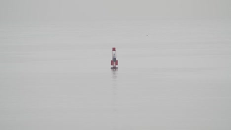Fishing-buoy-floating-in-calm-sea-in-a-cloudy-day-in-slow-motion-60fps