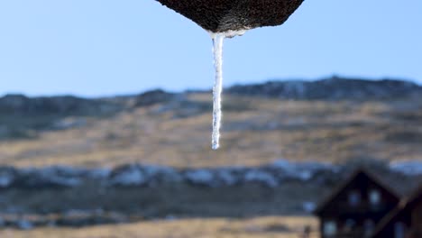 Snow-melting-icicle-with-water-dripping