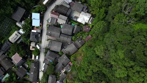 Flight-above-Mae-Kampong-village,-looking-down-at-town-and-greenery