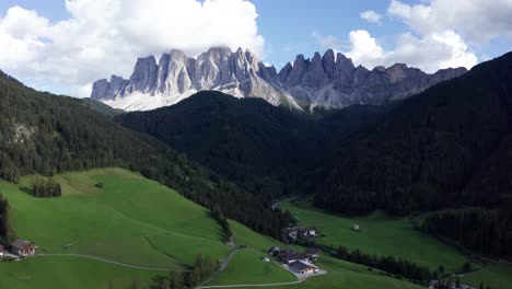 Val-Di-Funes-mountain-valley-in-Italian-Dolomites,-establishing-wide-aerial-shot