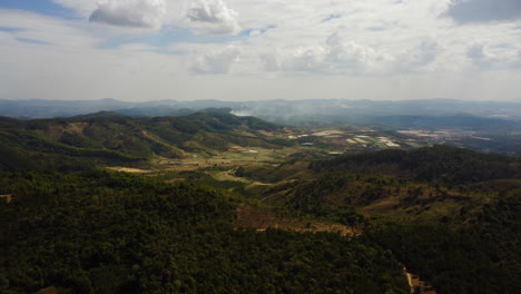 Aerial-flying-over-rural-Tu-Tra-area,-fire-smoke-in-background,-Vietnam