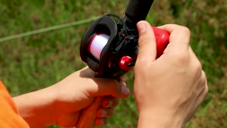 Close-Up-Shot-of-Bass-Fishing-Reel-being-reeled-in