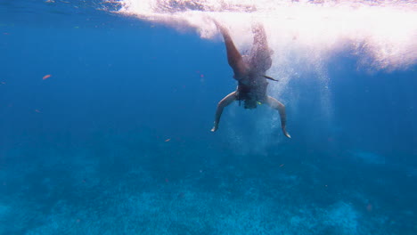 Swimmer\diver-learning-and-trying-to-dive-in-deep-blue-sea-in-Caribbeans-with-safety-gears-on-|-Snorkeling,-Diving,-Holidays,-Training,-Adventure,-Vacation,-safety-conceptual-background