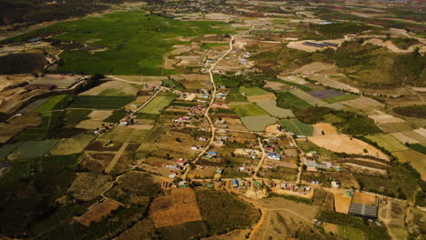 Rural-farmland-landscape-with-small-town-in-Vietnam,-aerial-drone-view