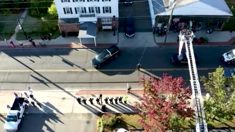 DRONE-FOLLOWING-HEARSE-AT-FUNERAL-PROCESSION