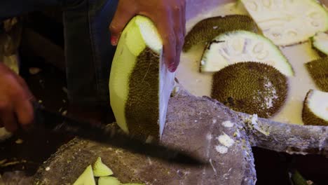 man-chopping-fresh-organic-unripe-jack-fruit-for-vegetable-from-farm-close-up-shot
