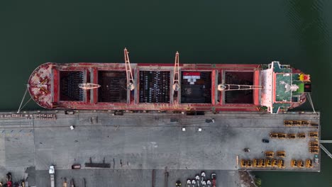 Top-down-aerial-of-cargo-ship-at-harbor-dock