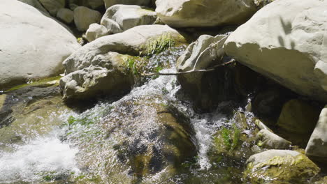 Stationary-shot-of-small-waterfall-running-into-creek-located-in-Santa-Paula-Punch-Bowls-Southern-California