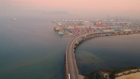 Aerial-view-moving-foward-of-Algeciras-port,-close-to-the-container-terminal-and-the-bridge-that-connects-to-the-port