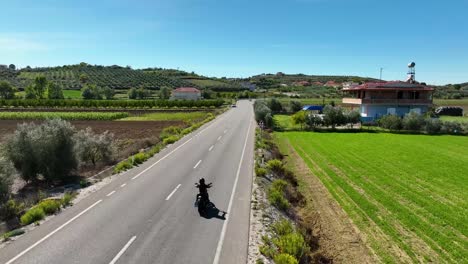 Motorcycle-chopper-riding-on-countryside-near-farmland