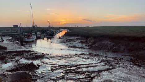 Boats-docked-in-the-estuary-with-amazing-golden-sunset
