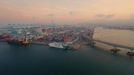 Aerial-view-of-Algeciras-port,-close-to-the-container-terminal-with-some-vessel-alongside