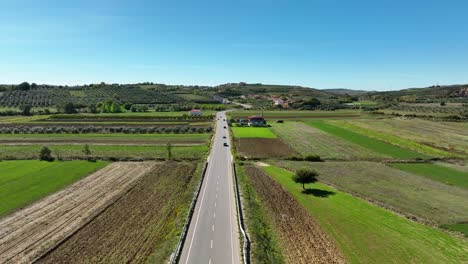Rural-road-with-small-traffic-near-agricultural-farmland