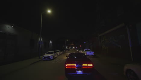 Police-cars-patrol-at-night-in-Los-Angeles,-Georgia,-USA
