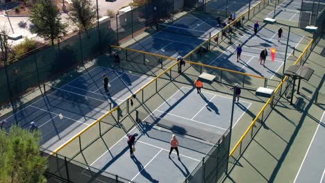 People-playing-pickleball---high-angle-aerial-view-of-city-park-courts