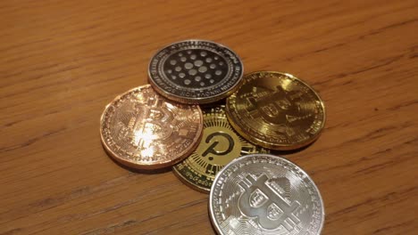 Kryptowährungen-Für-Digitales-Geld-Wie-Blockchain-Token-Und-Web-3-Bitcoin-Und-Polkadot,-Die-Das-Licht-Auf-Der-Holzoberfläche-Reflektieren,-Nahaufnahme-Oben,-Galicien,-Spanien