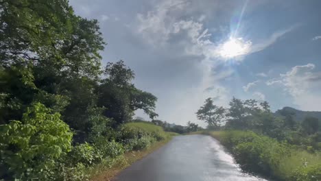Driving-Across-The-Wet-Road-After-The-Rain-Near-Kalsubai-Harishchandragad-Wildlife-Sanctuary-In-Western-Ghats,-Maharashtra-India