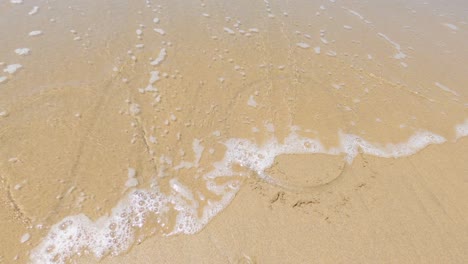 Word-no-drawn-on-beach-sand-being-covered-by-sea-wave