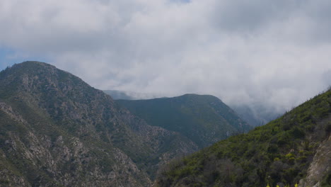 Time-lapse-of-ravine-with-white-clouds-flying-over-them-located-in-Echo-Mountain-Trails-California