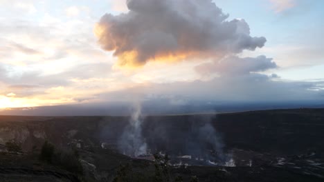 Smoke-steam-rises-from-volcano-national-park-into-the-sky-during-sunrise-with-a-large-golden-cloud-looming-overhead