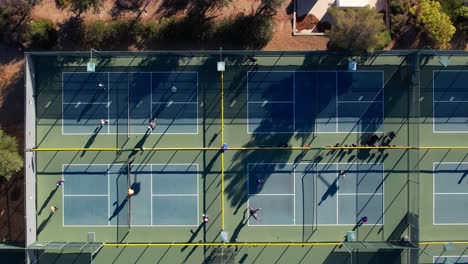 Top-down-aerial-view-people-playing-pickleball-on-outdoor-sport-courts