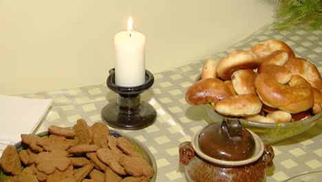 Christmas-table-full-of-gingerbread,-pies-and-candles